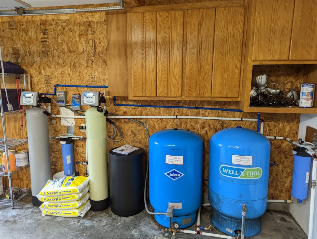 Whole-home water treatment system with softener and filtration tanks installed in a Burlington, WA garage